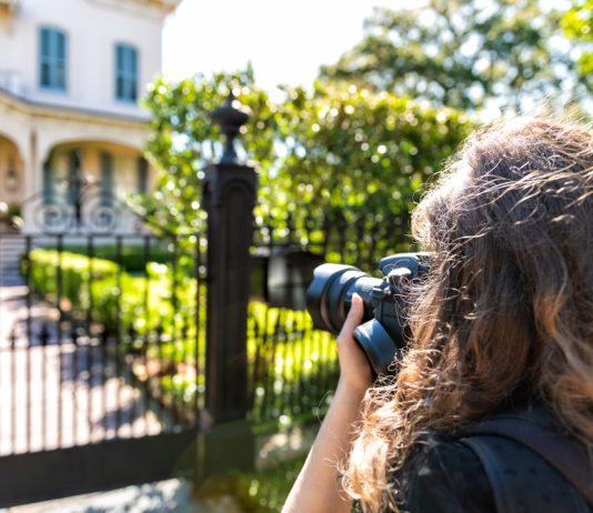 Tips for Starting a Real Estate Photography Business real estate photographer taking picture of house
