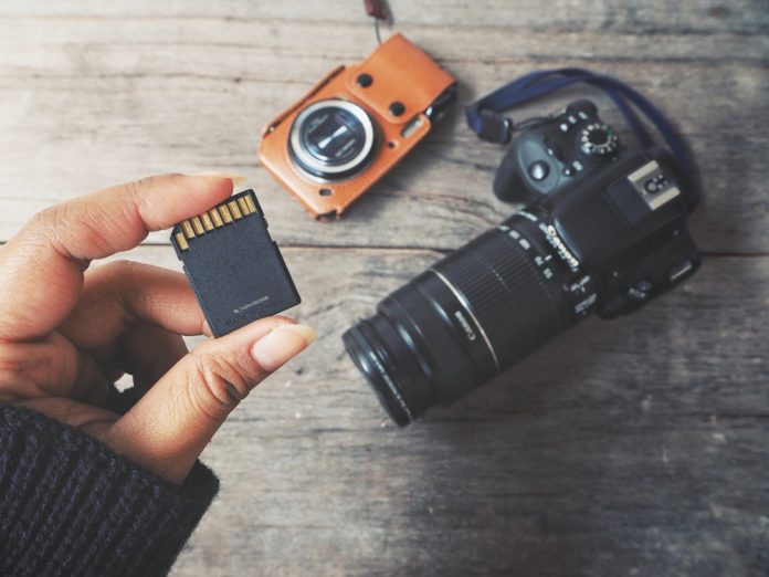 woman holding a memory card