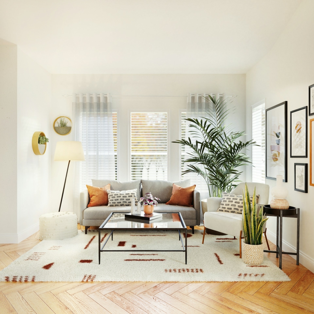 living room with orange couch pillows and a big plant