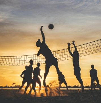 Best Camera Settings for Sports: How to Capture Fast Action With Confidence silhouette of people playing Beach Volley ball