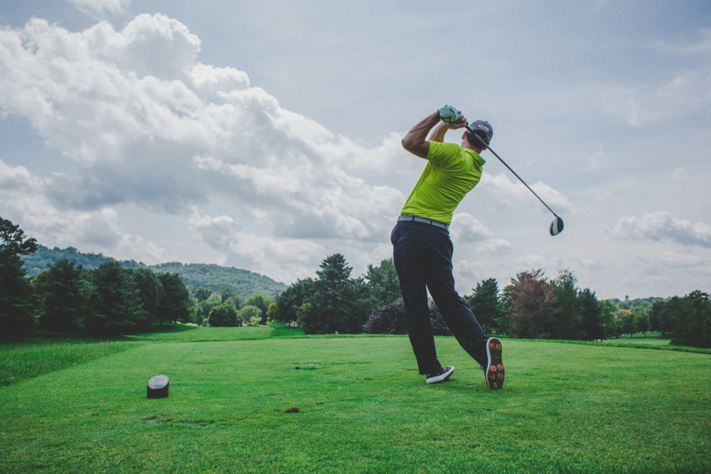 man swinging golf driver