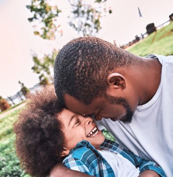 How to Capture Authentic Expressions in Portrait Photography father and his child hugging in the park