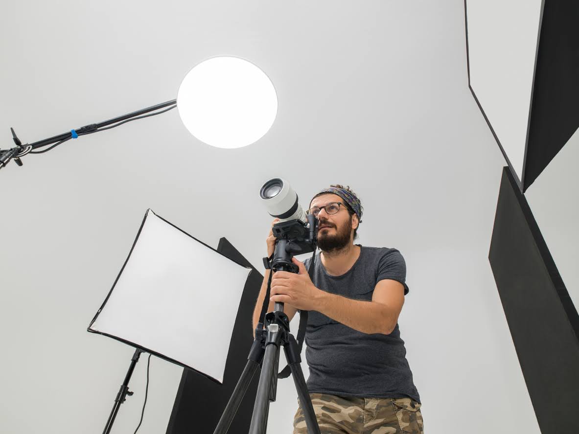 Portrait of photographer with Dslr format camera