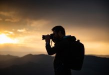 Canon EOS R1 Review: Flagship Speed Built for Pros male photographer in nature at sunset