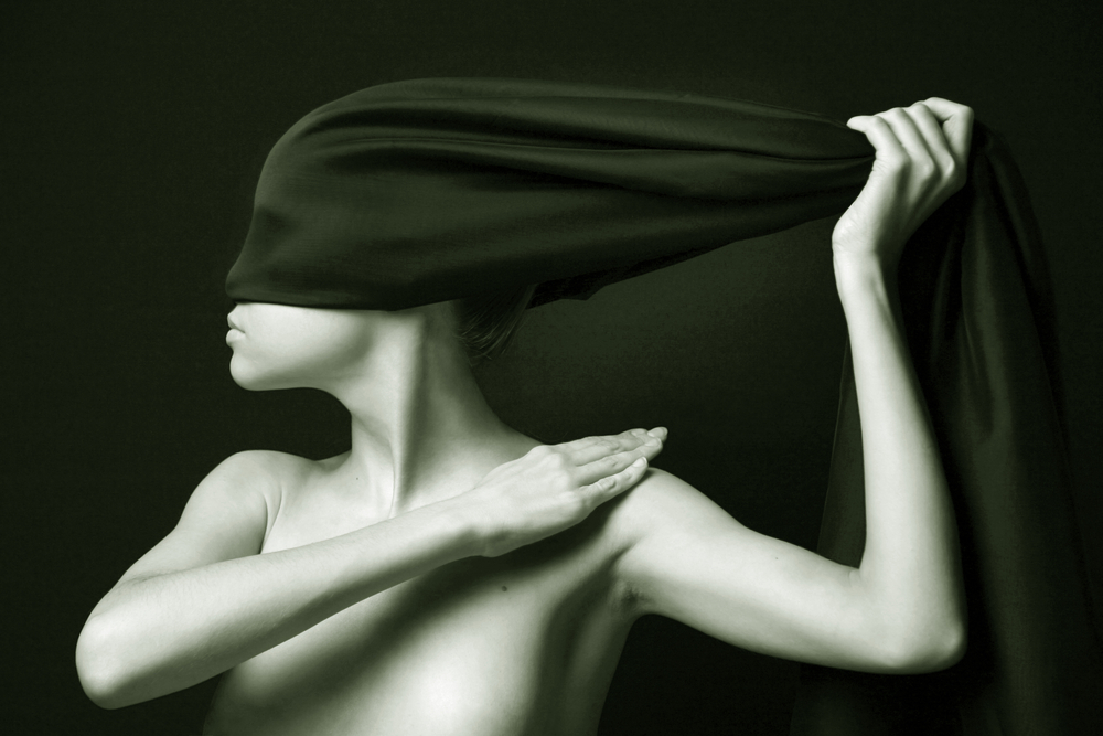 nude woman with black cloth wrapped around face and head