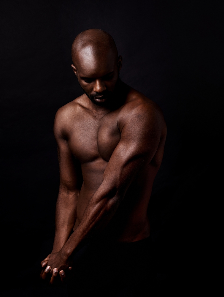 Nude man looking down