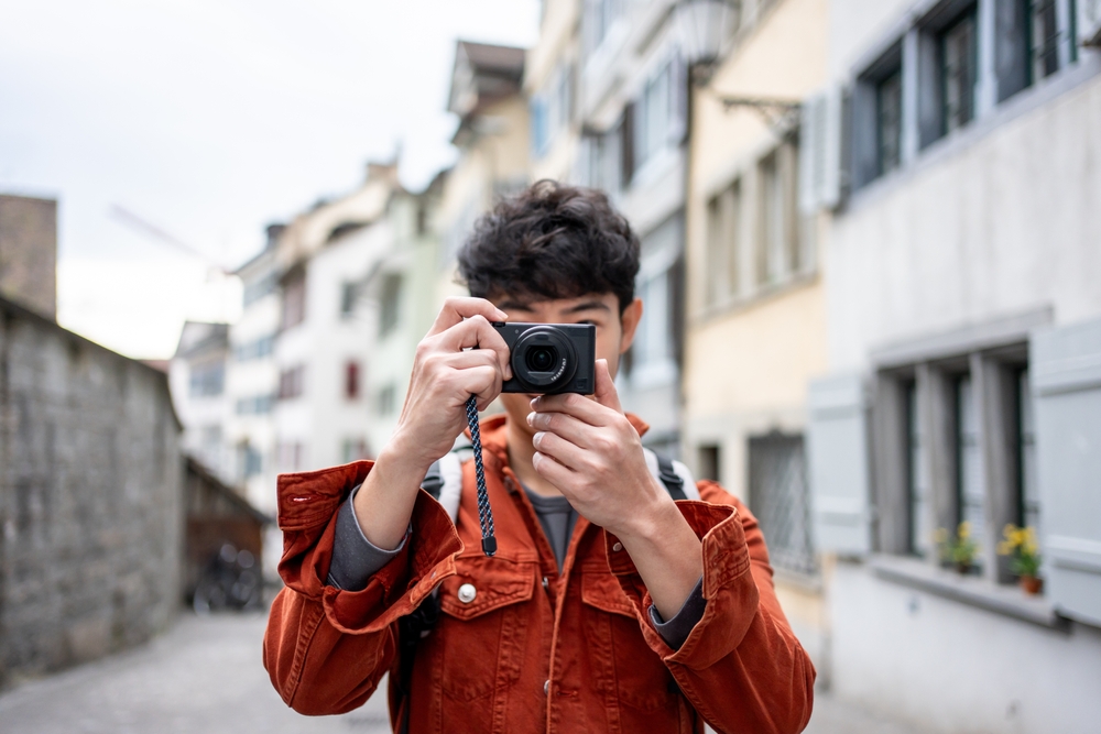 Photographer using a compact camera