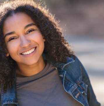 Understanding Depth of Field in Portrait Photography young woman smiling laughing with perfect teeth