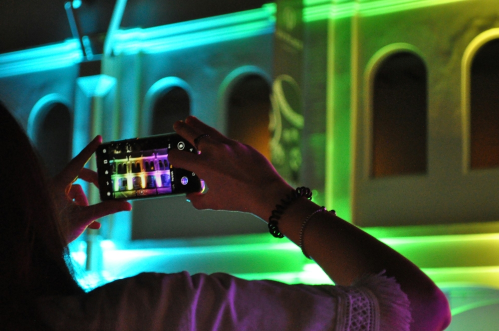 Taking a photo of a colorfully lit building with a smartphone