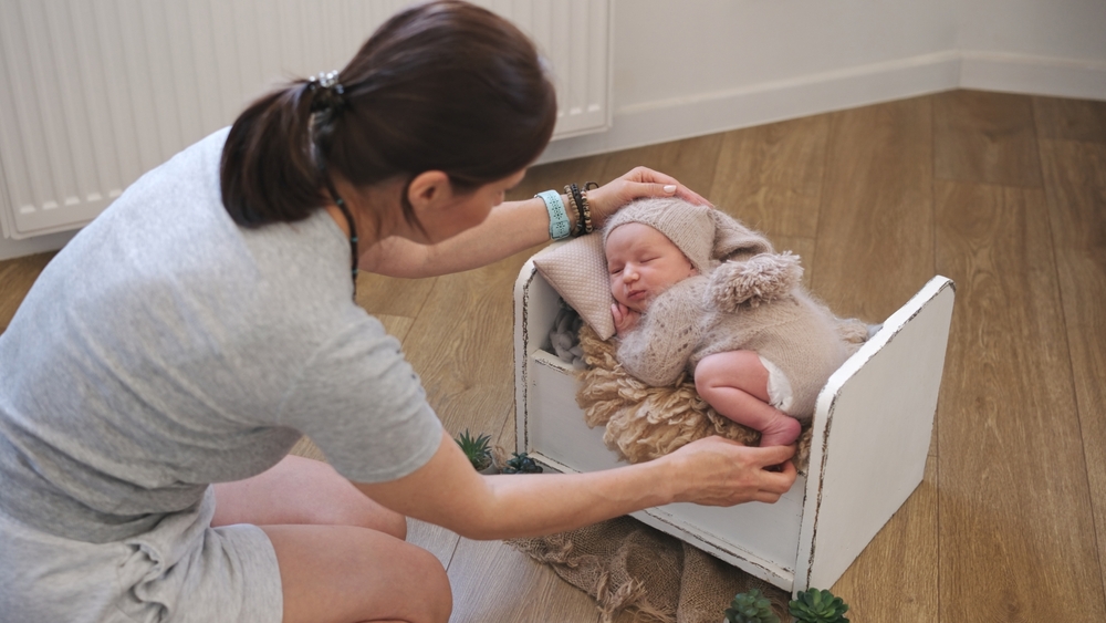 Photographer posing a newborn baby