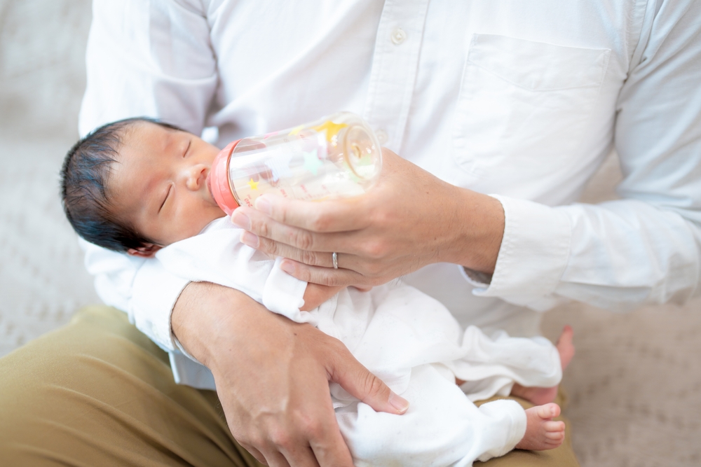 Newborn baby being fed
