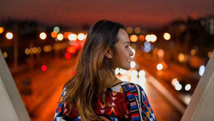 Woman standing with bokeh lights in front of her