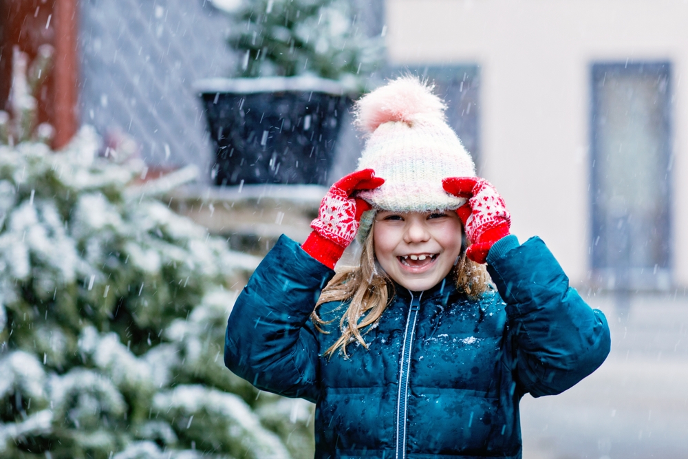 Little girl playing in the snow
