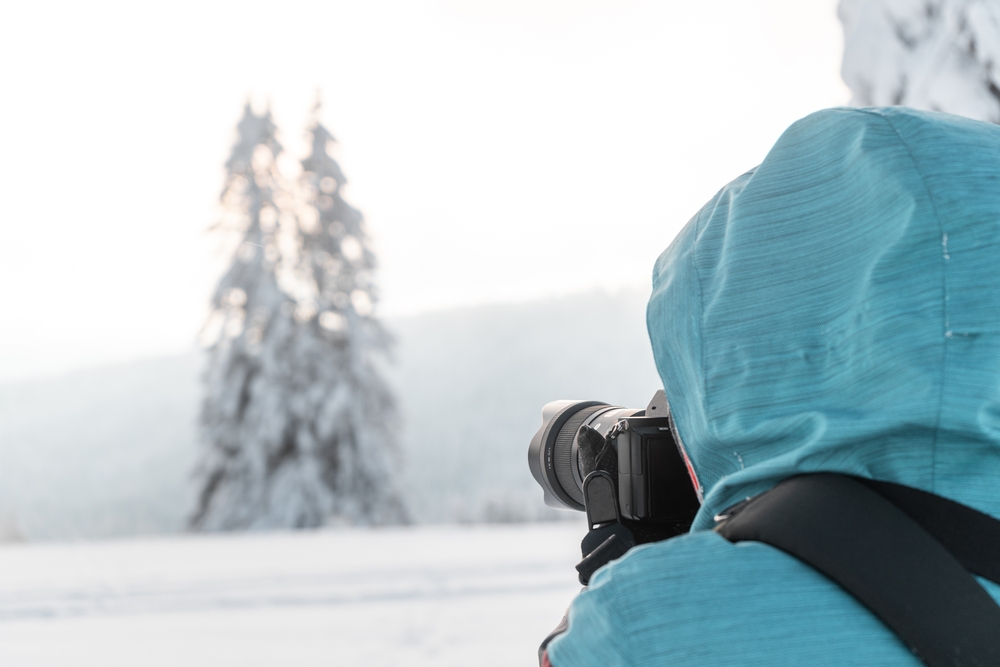 photographer taking photos in a winter landscape