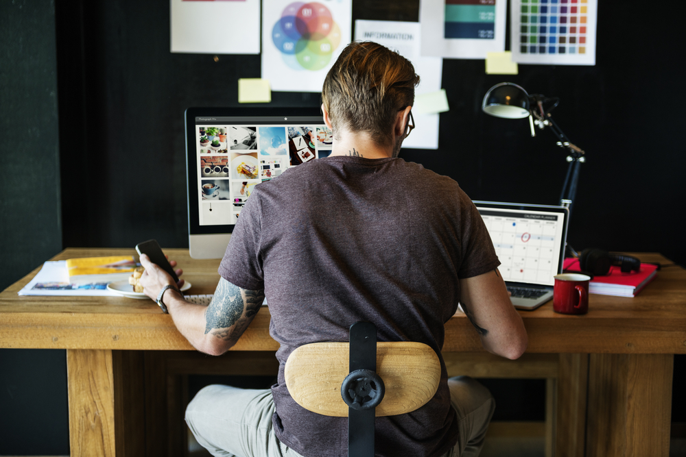 Photographer Editing images on his computer in his office