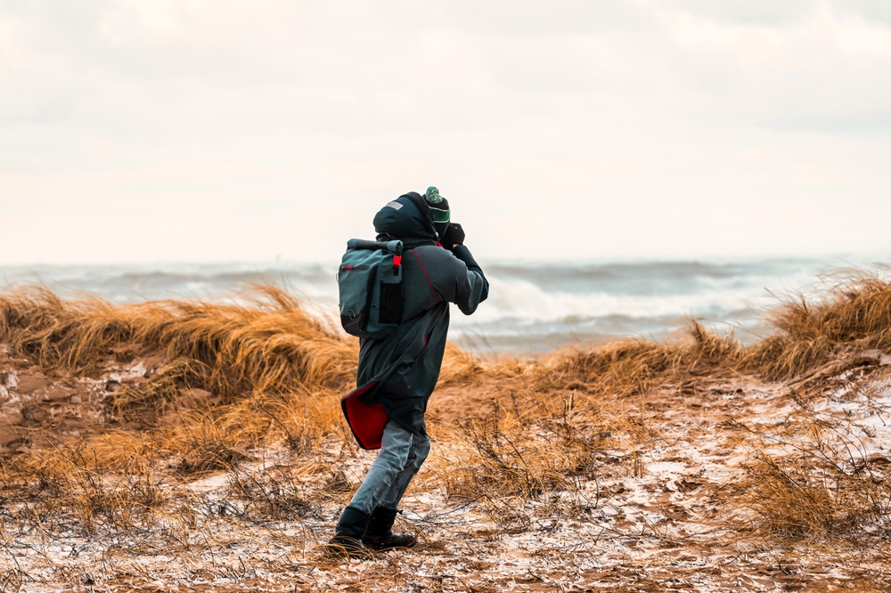 photographer at the coast photographing in winter