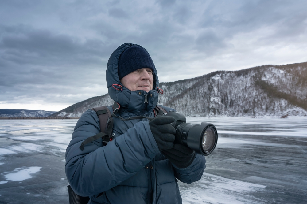 photographer taking pictures of a frozen landscape