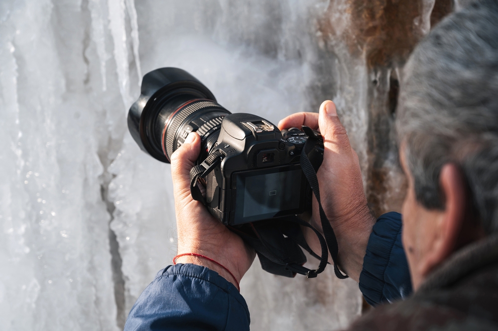 photographer shooting icicles in winter in close-up