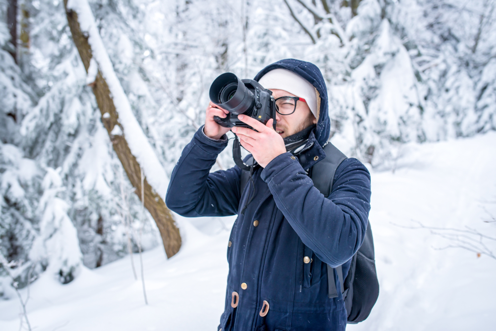 photographer in a winter forest