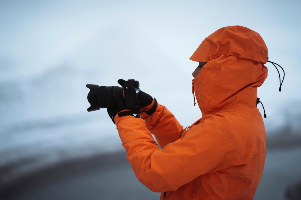 Photographer in orange capturing winter scenes