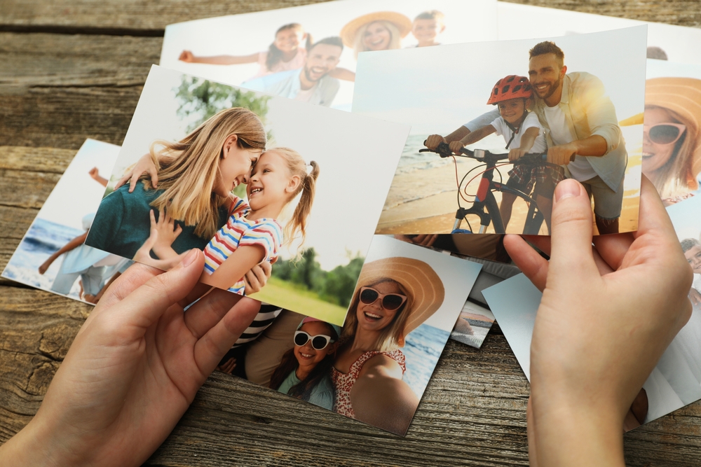Woman holding family portraits