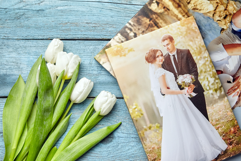 Wedding portrait and bouquet of tulips on a blue table