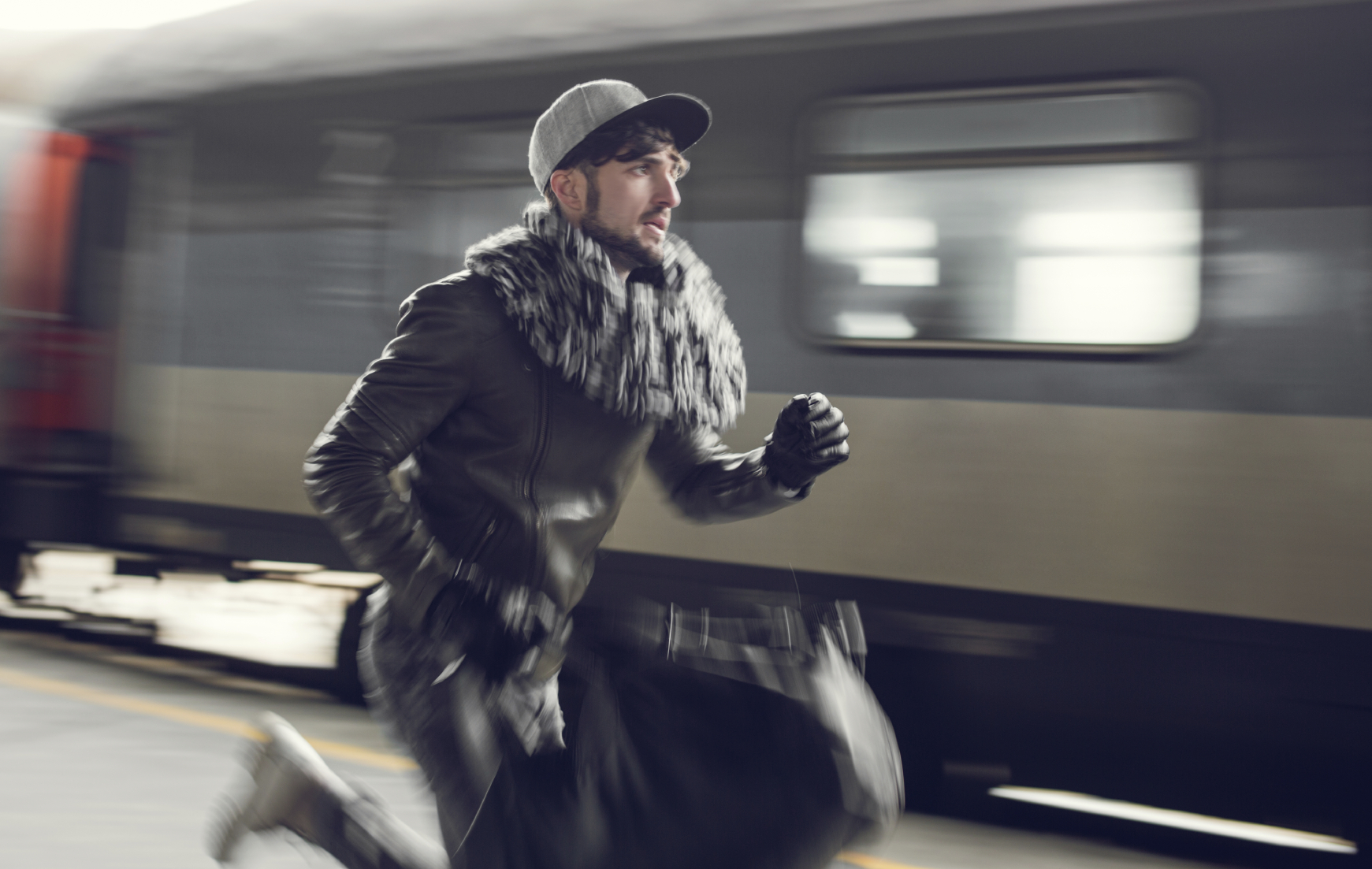 Man running next to moving train motion blur