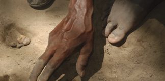 Person reaching for sand