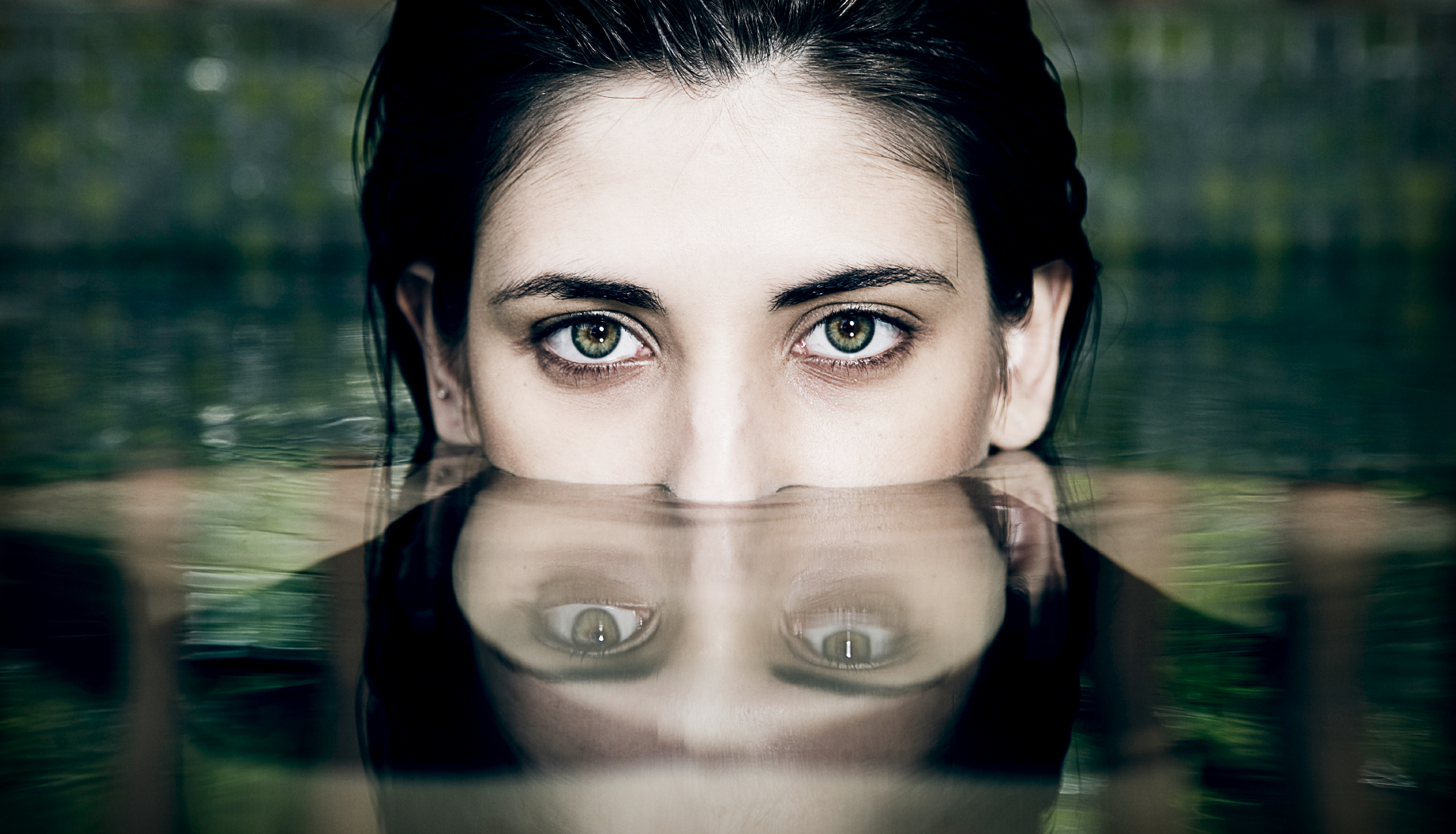 Reflection of woman's face as she comes out of the water