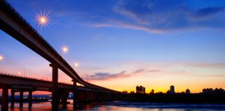 Sunset over a curving bridge