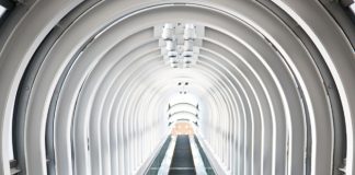 Looking up an escalator with an arched ceiling