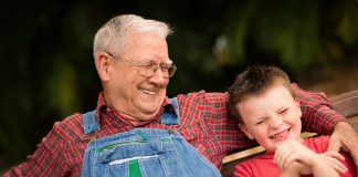 Boy and his grandfather laughing