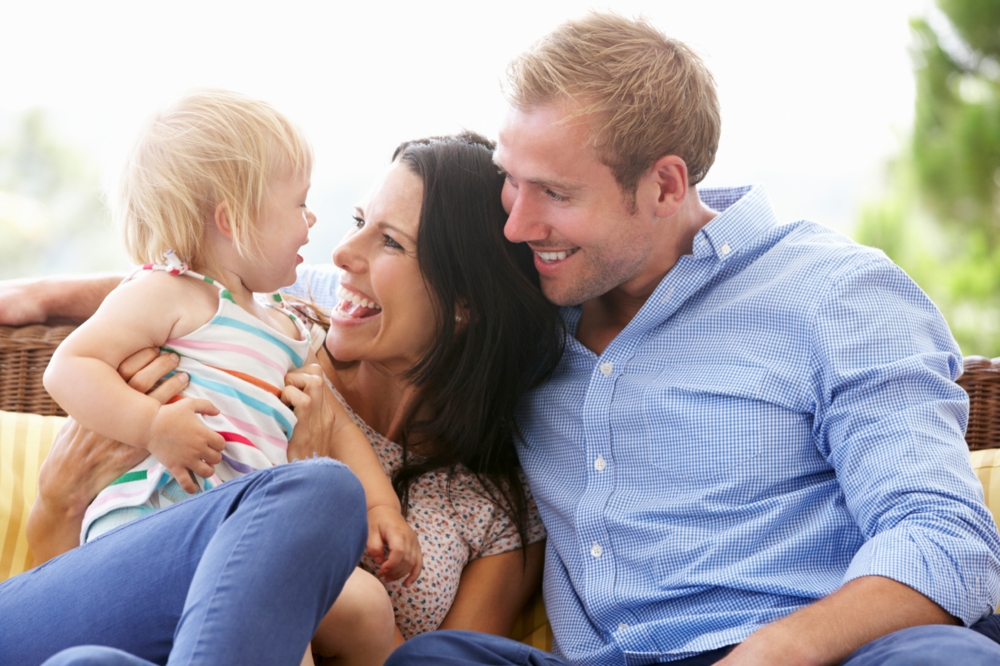 Mother and father laughing with baby