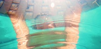 person's face half underwater