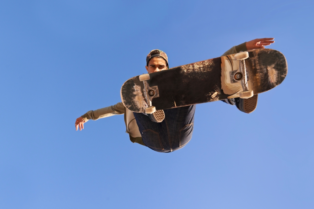 man doing a skateboard trick in above the camera