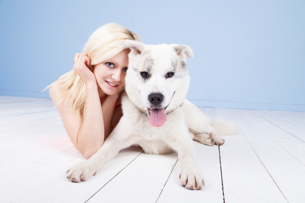 woman and her dog lying on the floor professional portrait