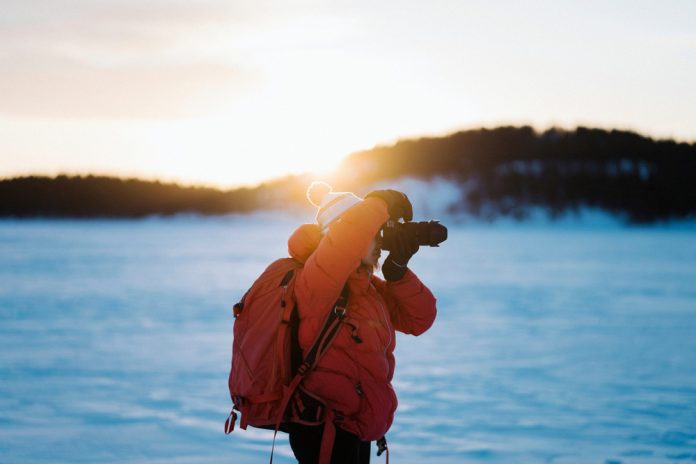 female photographer capturing a winter scene
