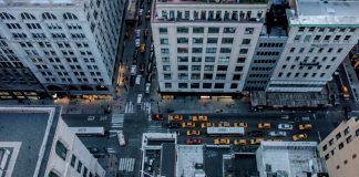 looking down from the top of a tall building on to the street below