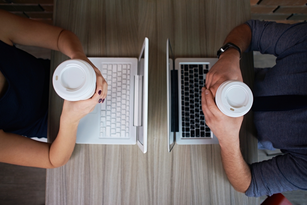 birds eye view of people having coffee and using laptops