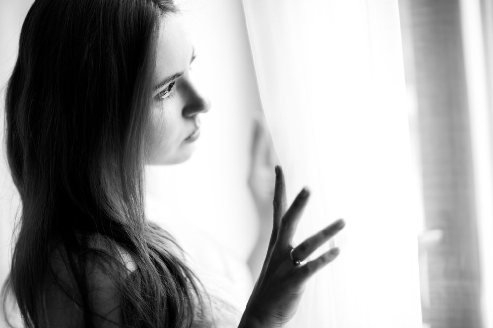 Woman looking through light curtains
