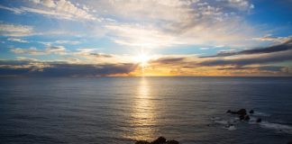 Sunset over the ocean with a sunburst