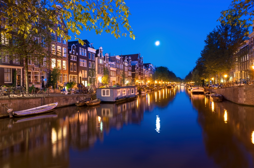 Houses reflected in a river at night