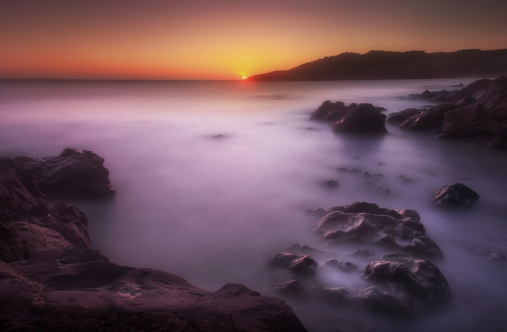 Long exposure rocky ocean coast sunset