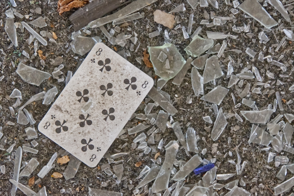 dirty eight of clubs on the ground