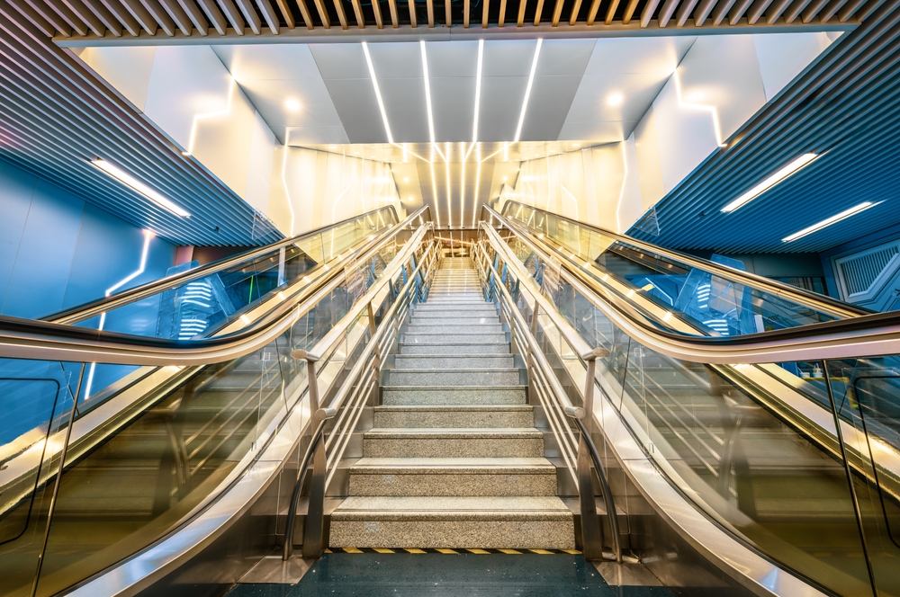 Modern escalators and stairs leading up symmetry