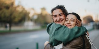 two happy women hugging