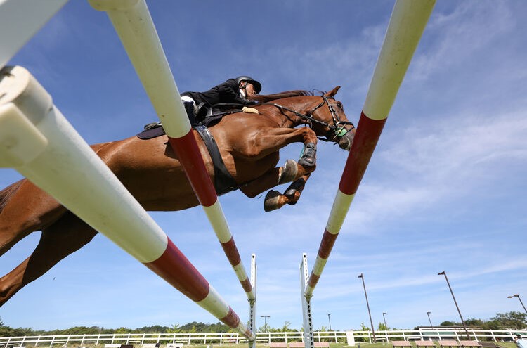 Canon EOS R6 Mark II man riding a jumping horse low angle