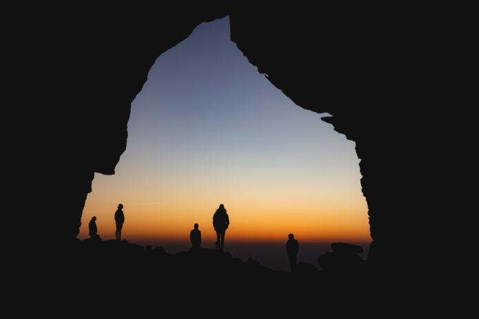 silhouette of people in a cave