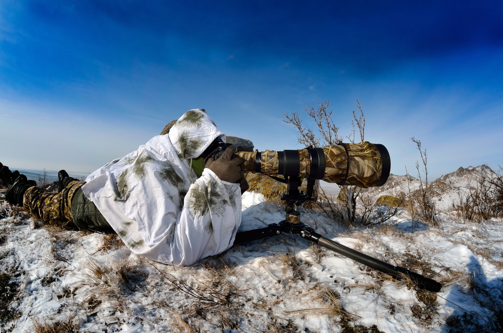 winter photographer with telephoto lens