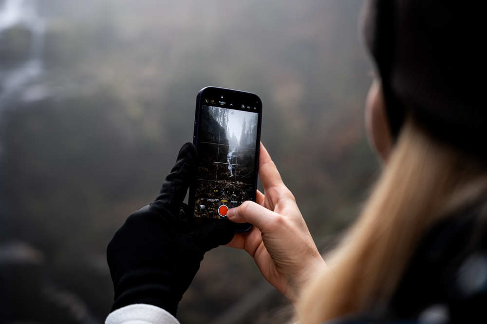 woman composing a rainy photo with smartphone